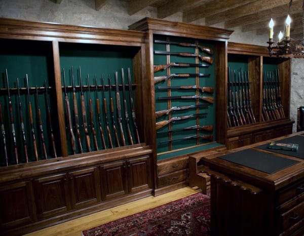 Gun Collector Room With Rifles And Shotguns Mounted On Wall Rack