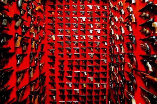Incredible Room With Wall Mounted Pistols And Red Paint