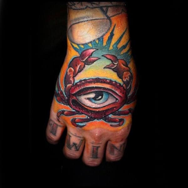 Male With Tattoo Of All Seeing Eye Red Crab On Hands