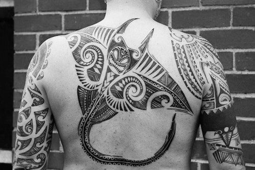 Man With Tattoo Of Stingray Tribal Design On Upper Back