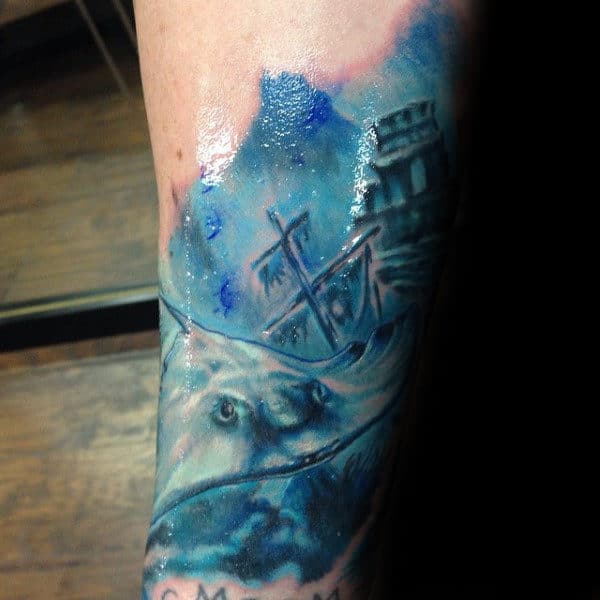 Realistic Underwater Ocean Stingray With Sunken Ship Tattoo On Man’s Arm