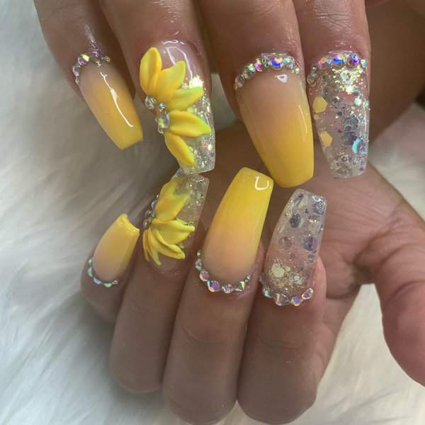 Yellow nails with sunflowers and glitter