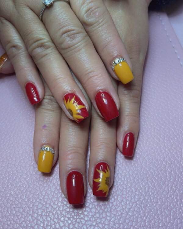 Red and yellow nails with sunflowers