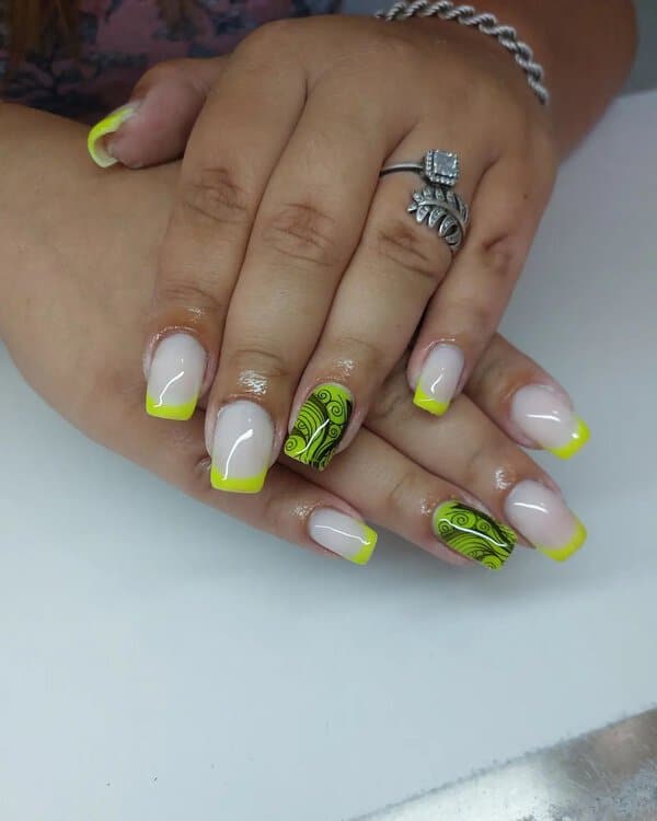 Neon yellow French tips and patterned nails