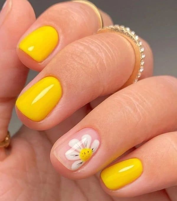 Yellow nails with daisy accent nail