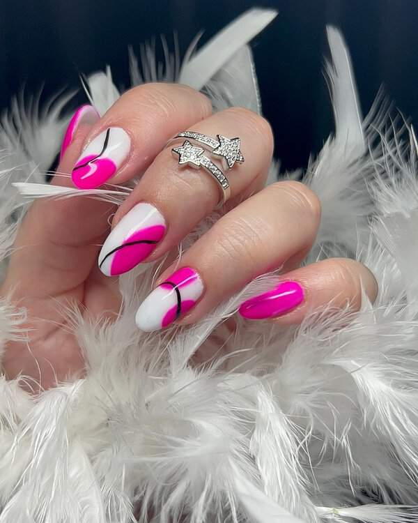 Pink and white nails with black swirls