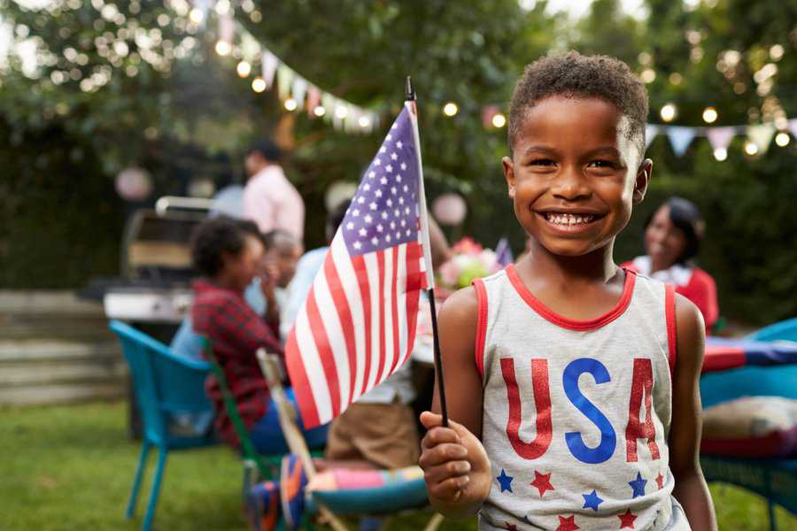 boy holding american flag 4th of july