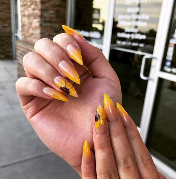 Yellow stiletto nails with sunflowers