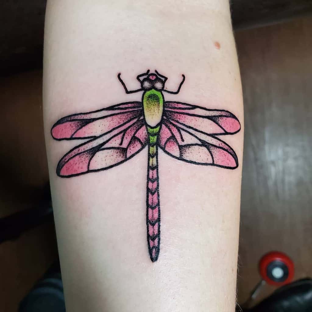 A nice yet vibrant tattoo of dragonfly pointing the vibrancy in all its glory 