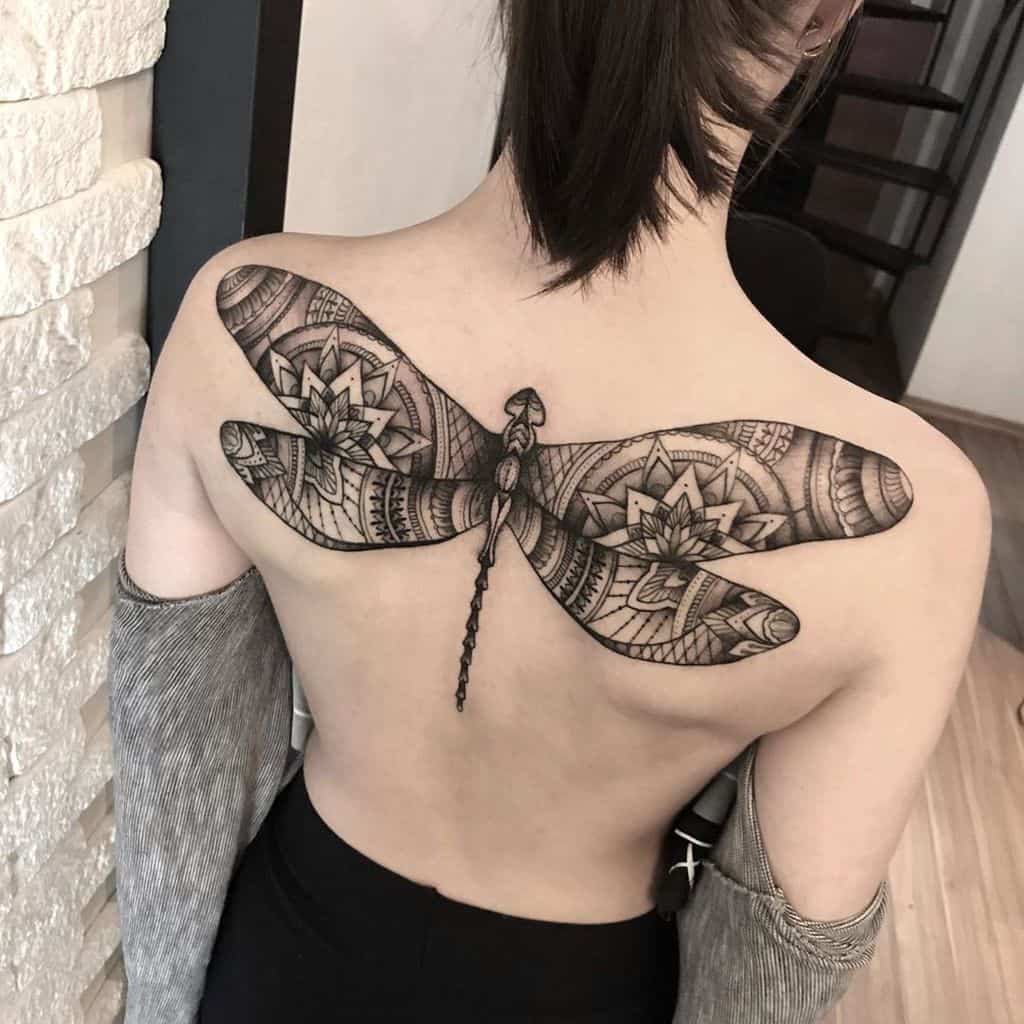 A colossal dragonfly covvering the whole back in the most boho way possible 