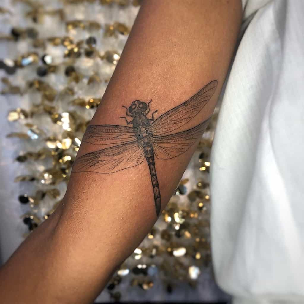 A perfectly sculptured dragonfly on the color of skin to pose an image of peace