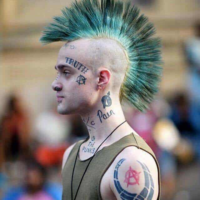 an old school cyberpunk Mohawk featuring long and sleek fanned hair in centre shaded blue at the bottom and two colours blend at the middle and tips