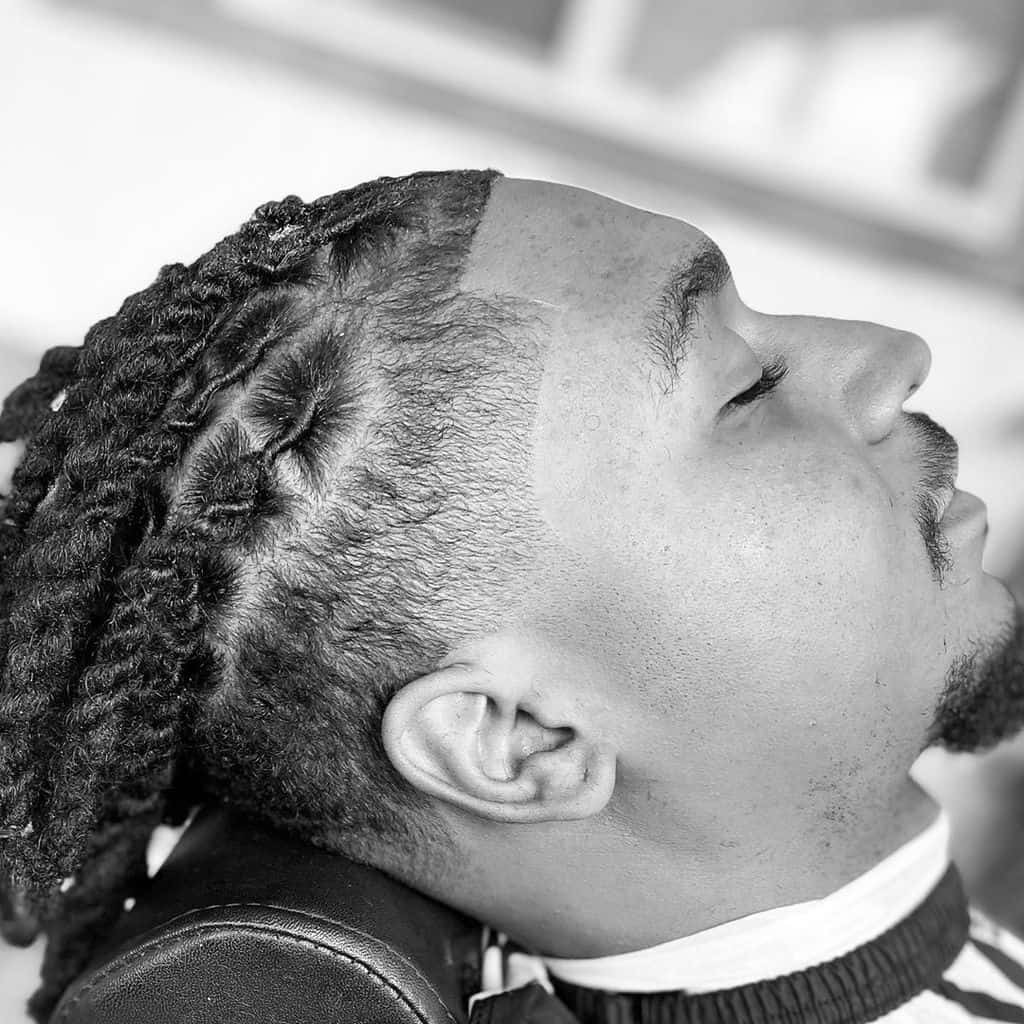 A Braided Men’s Mohawk Hairstyle With Shaved Sides And Long Braids On Top Starting From The Front To The Back