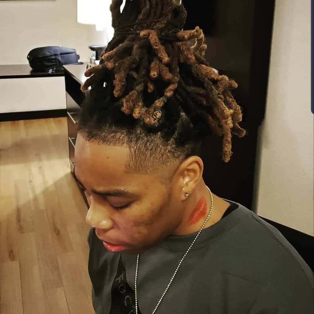 A Dreadlock Hairstyle Paired With Neat Undercut And Taper Fade