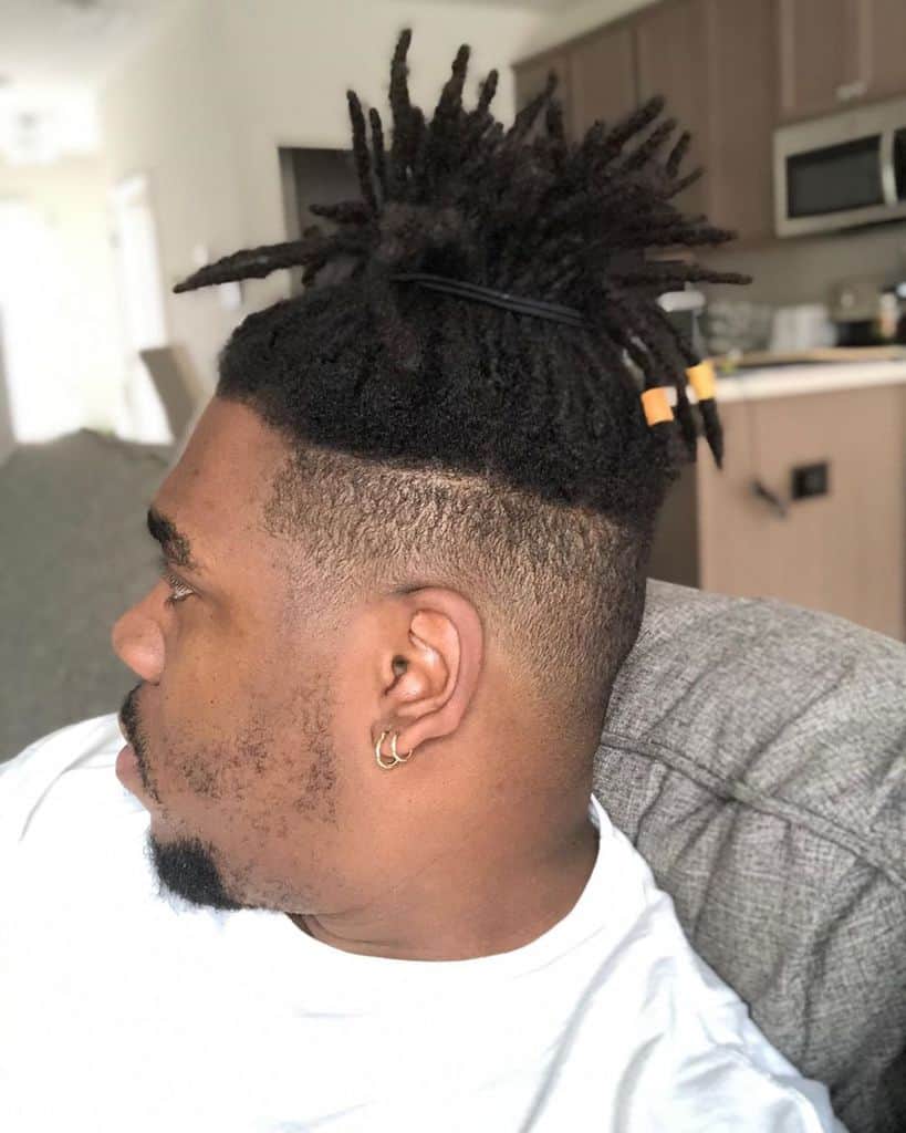 A Dreadlock Style With Long Dreads Swept To One Side And Paired With Short Hair On The Sides