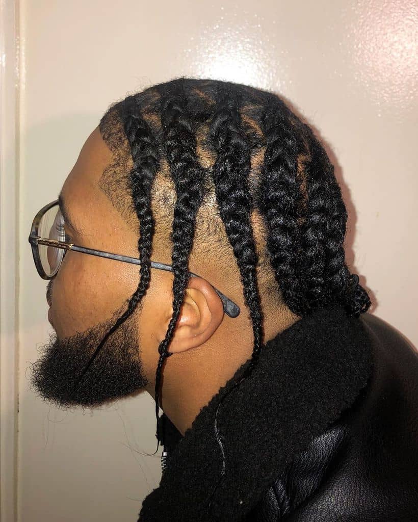 A Guy Wearing Big Cornrows With Thin Tips At The Nape Of The Neck