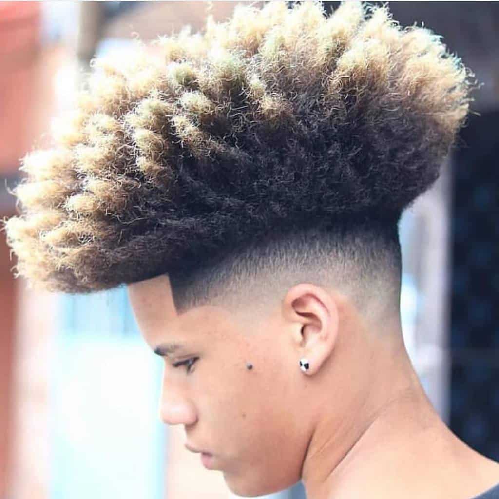 A Hi Fade Haircut With Blonde Highlighted Hair On Top And Faded Sides And Back