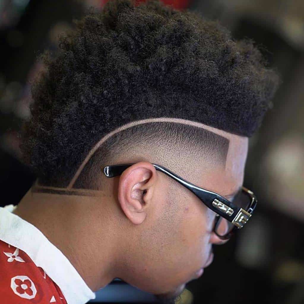 A High Top Fade Style With Long Hair Running From The Front To The Back And Paired With Faded Sides