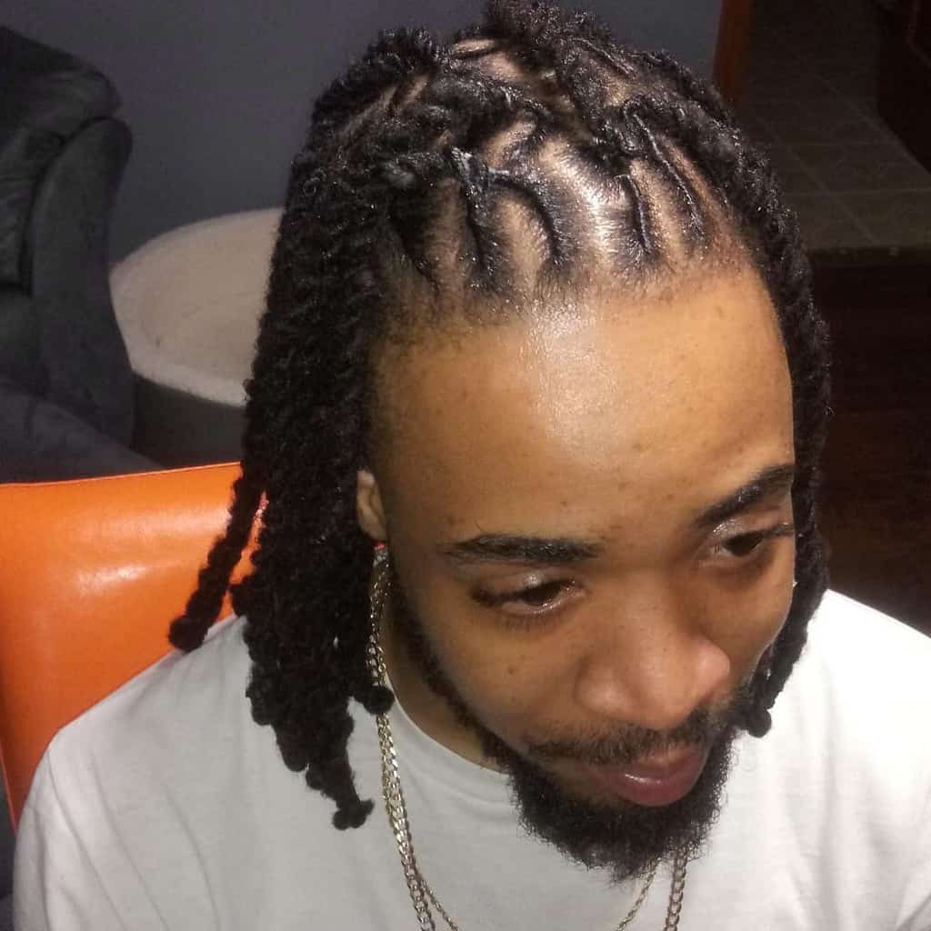 A Man Wearing Two Braid Twits Paired With Shaved Side