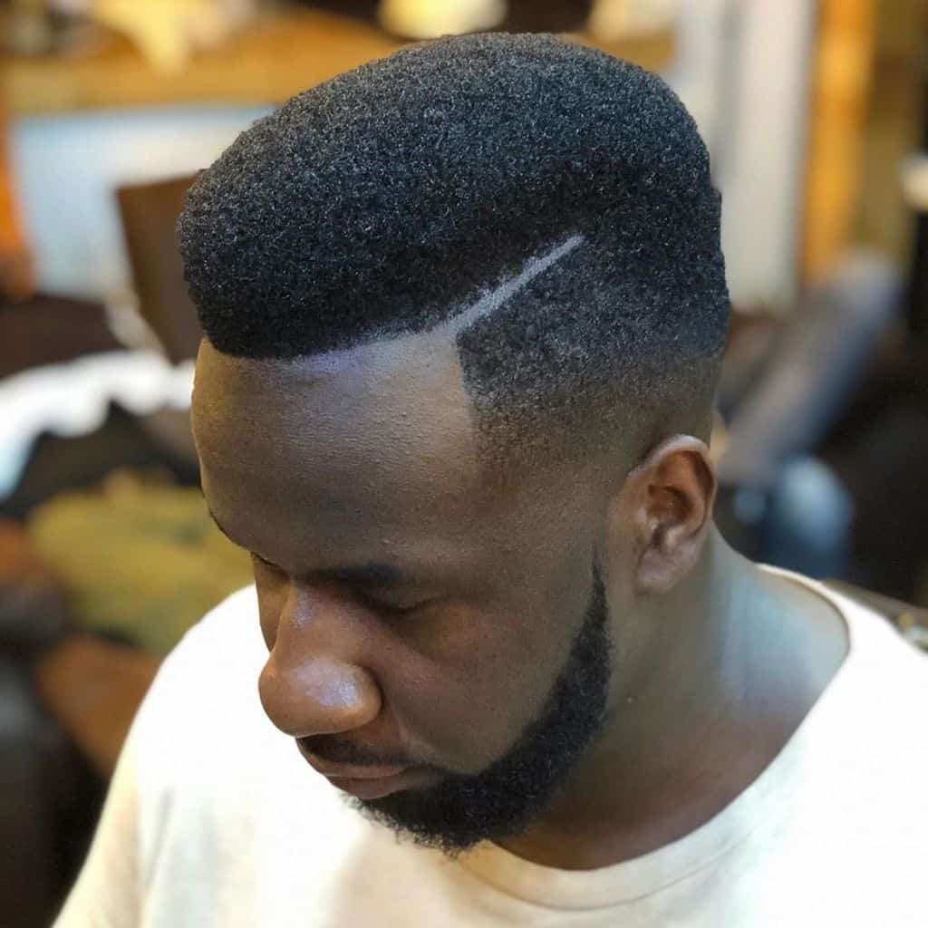 A Natural Hi Top Fade Style Featuring Thick Hair And Part