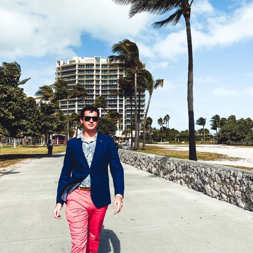 A Stylish Man Wearing Nantucket Reds (faded Chinos) And A Classic Navy Blue Blazer