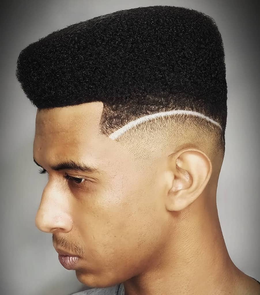 A Typical High Top Fade With Perfectly Combed Mid Length Hair And A Low Fade