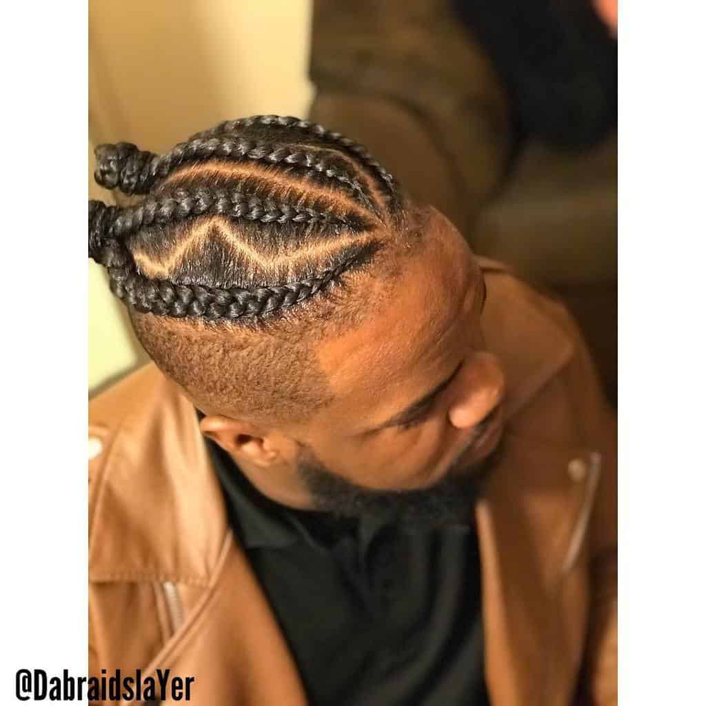 A Unique Man Bun Hairstyle With Two Knots And Undercut
