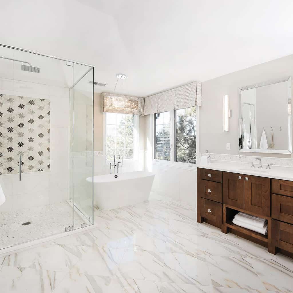 white bathroom with freestanding bathtub and wood cabinet vanity 