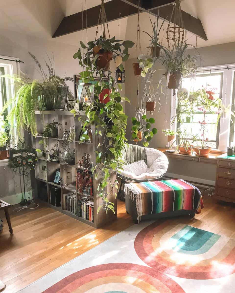 small living space with lots of plants and bookcase divider
