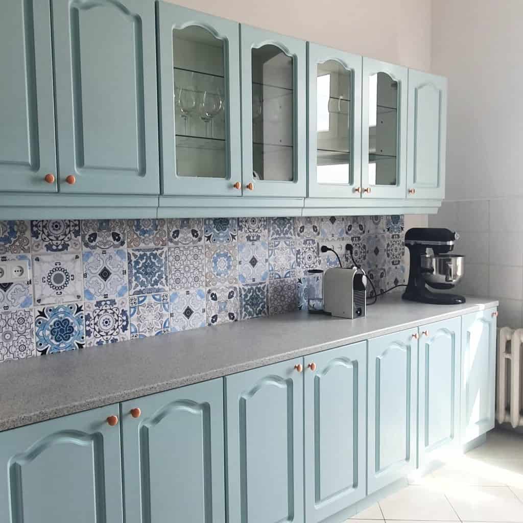 green kitchen cabinets with glass doors blue pattern wall tiles 