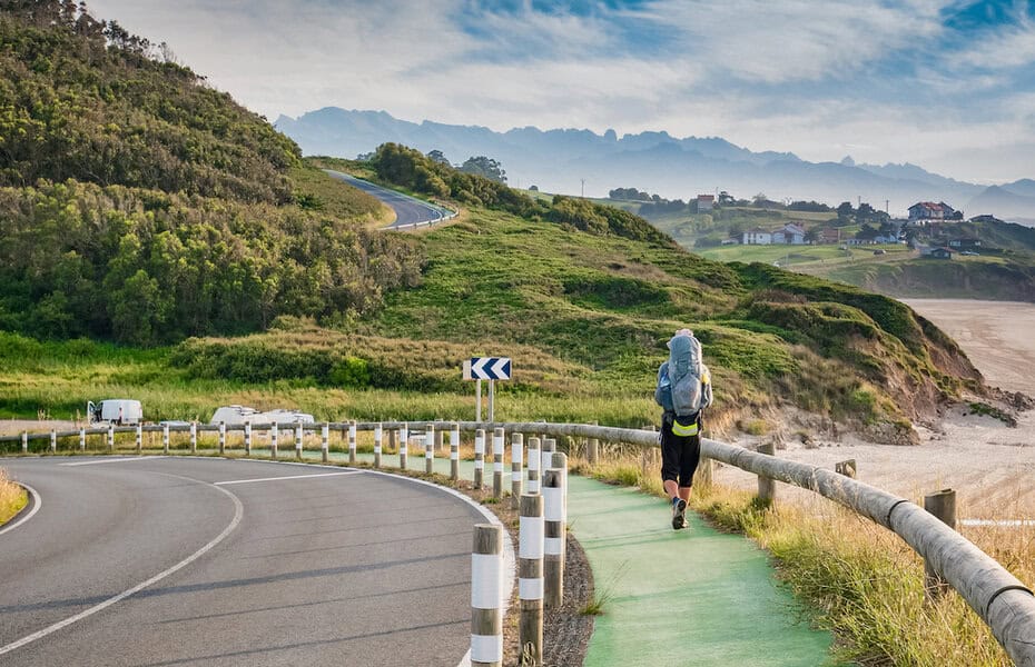 Lonely Pilgrim with backpack walking the Camino de Santiago in Spain, Way of St James