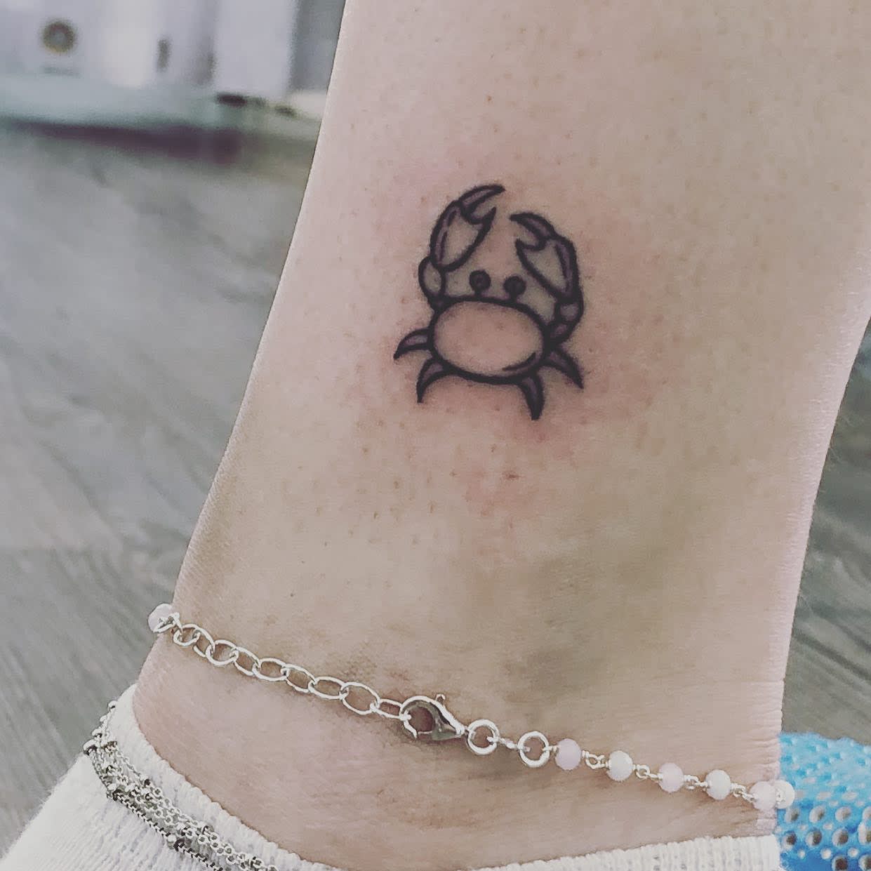 Hand poked crab tattoo on the ankle