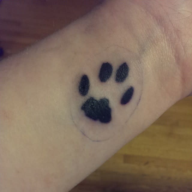 cat paw print tattoo on wrist