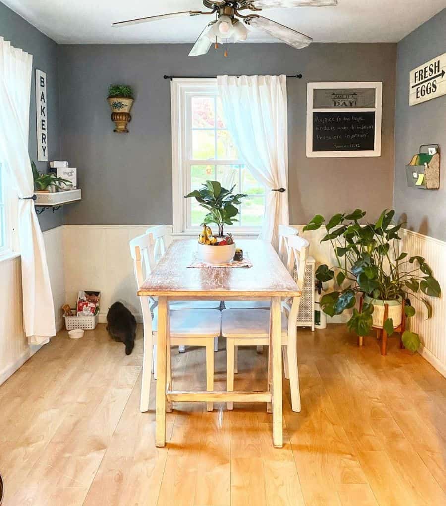 small dinning room white wood dining table and chairs ceiling fan with lights plants