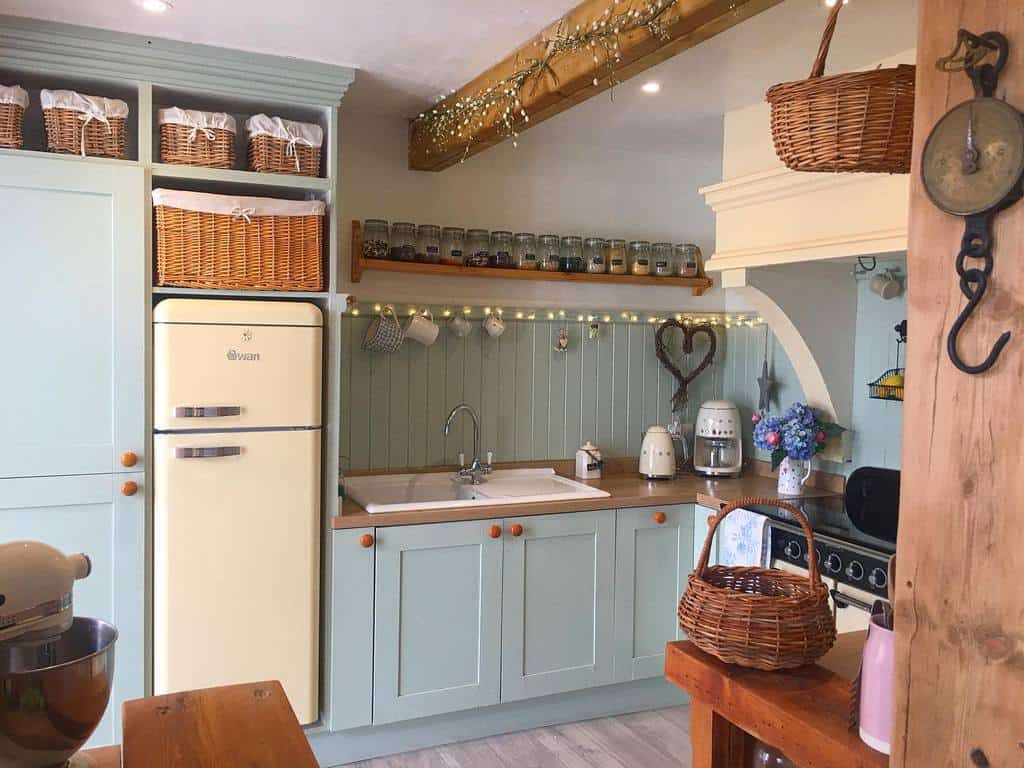 green kitchen cabinets vintage fridge wall shelf with spices weaved storage baskets