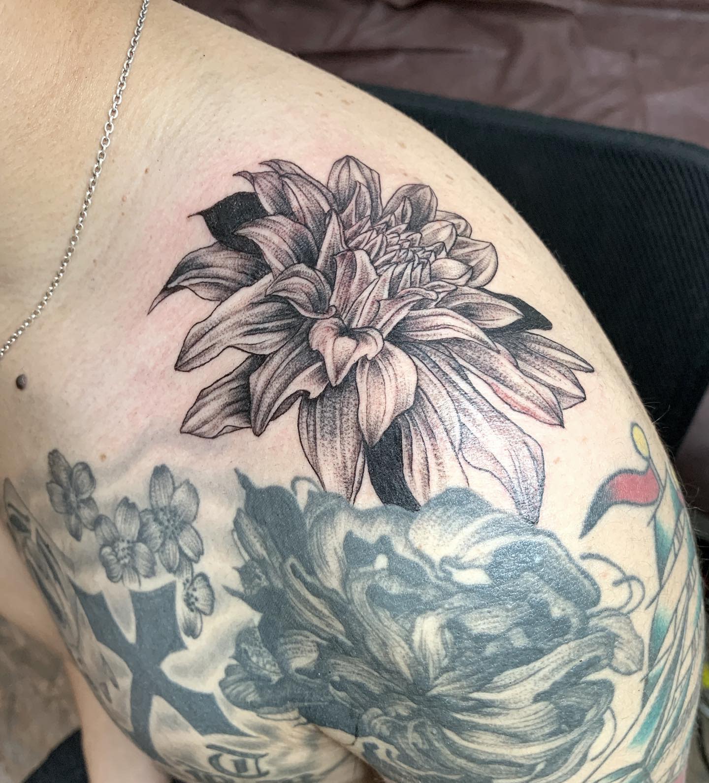 See 10 small but mighty dahlia tattoos