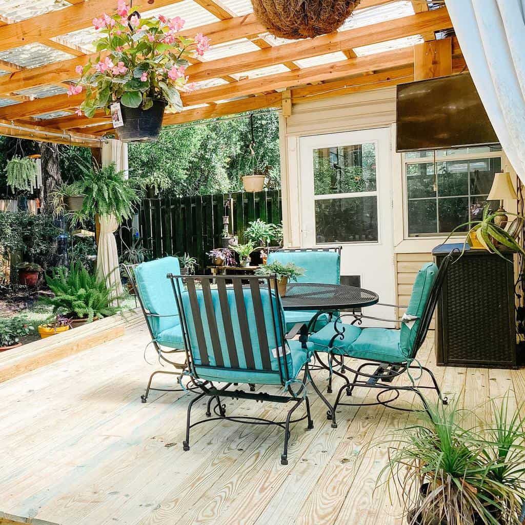 wood deck gazebo black metal outdoor furniture blue cushions plants