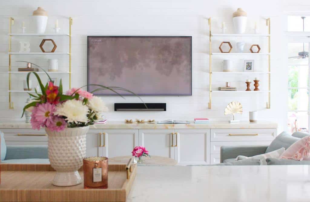 modern living room with white cabinets and gold accents 