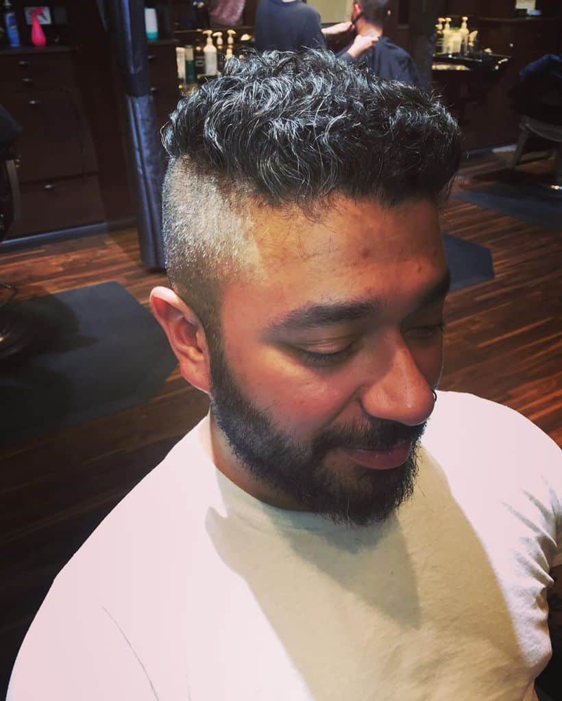 A funky crew cut featuring fauxhawk style on top and faded sides