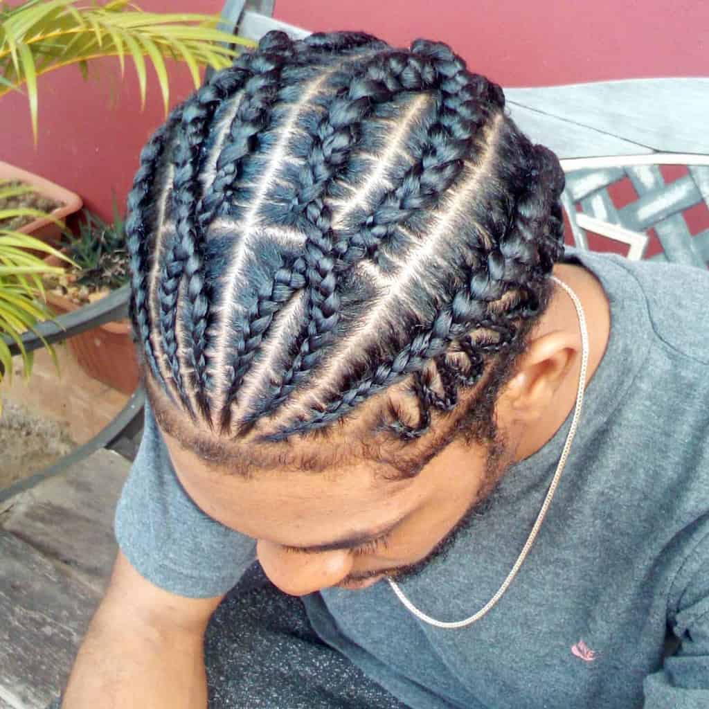 Feed In Cornrows Hairstyle With Thin Cornrows Starting On The Hairline And Growing Thicker As They Approach Center And To The Back
