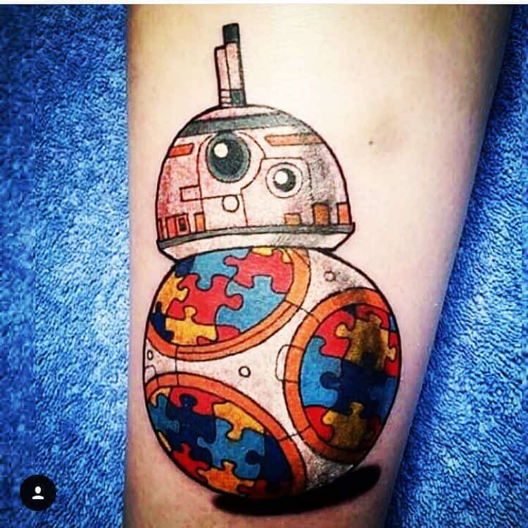 Full color forearm tattoo of Star Wars droid with Autism Awareness Puzzle designs. 