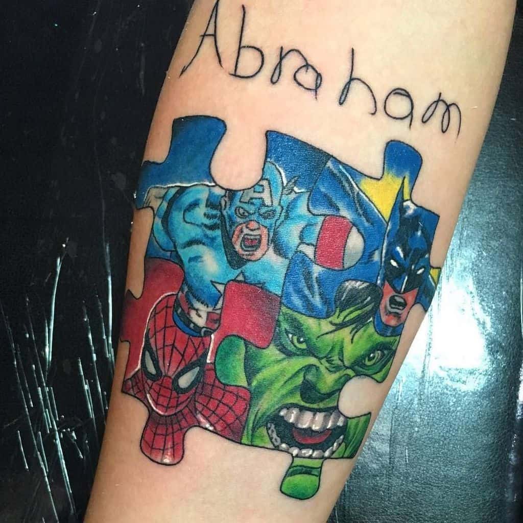 Full color forearm tattoo of a super hero puzzle piece with child’s script “Abraham”. 