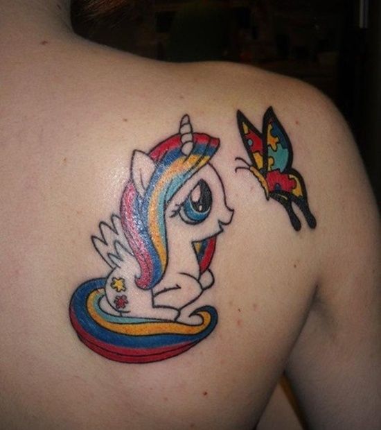 Full color shoulder blade tattoo of cartoon unicorn and Autism Awareness Puzzle butterfly. 