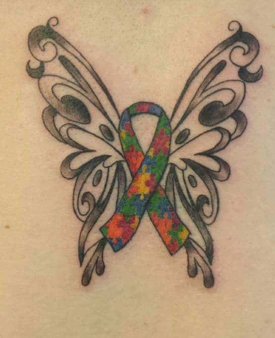 Full color tattoo of Autism Awareness Puzzle ribbon with stylized butterfly wings.