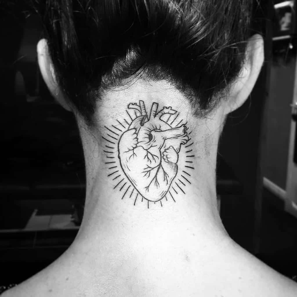 Tattoo of an anatomical heart with radiating lines on the back of neck