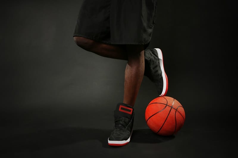 African,American,Basketball,Player,With,Ball,On,Dark,Background