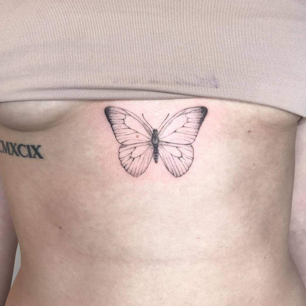 Single needle butterfly tattoo on inner arm