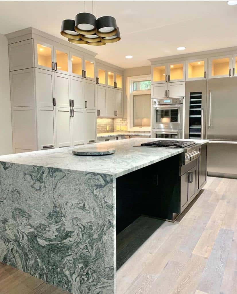 modern white cabinet kitchen with large marble island bench seating space