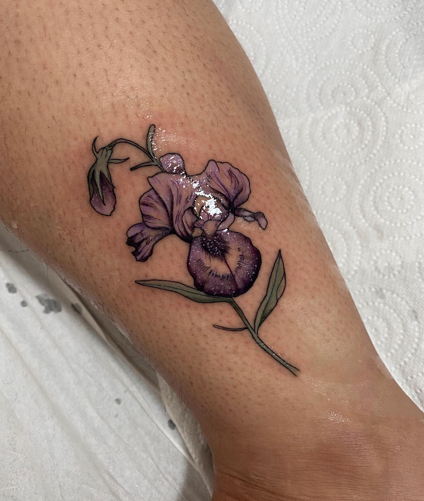 Iris flower tattoo located on the inner forearm