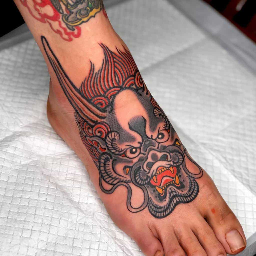 indres tribal dragon on her foot tattoo